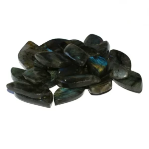 Labradorite Pendant Wholesale pile of dark polished stones with natural flashes on a white background