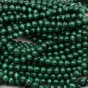 Malachite Beads Wholesale – close-up of polished round beads showing light and dark green patterns