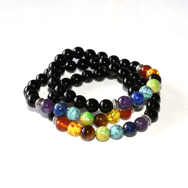 Mens Chakra Bracelet Wholesale showing stacked black bead bracelets with seven-color accents