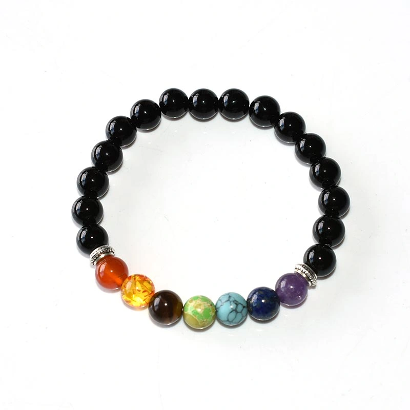 Mens Chakra Bracelet Wholesale worn on a wrist with black beads and seven-color accents