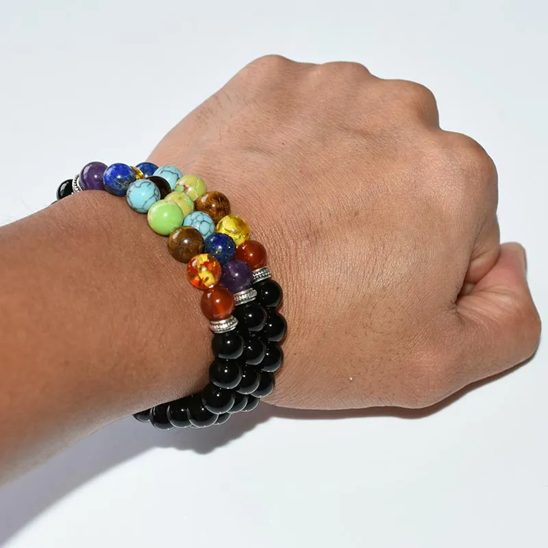 Mens Chakra Bracelet Wholesale worn on a wrist with black beads and seven-color accents