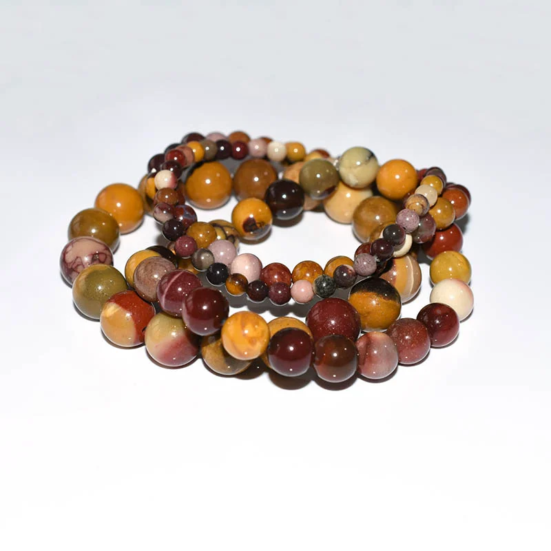 Mookaite Jasper Bracelet Wholesale showing several mixed-color round bead bracelets arranged together