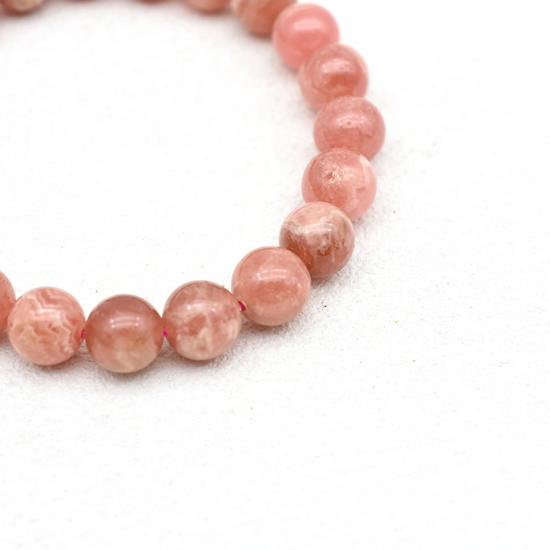 Rhodochrosite Bracelet Wholesale – close-up of pink round beads showing varied natural patterns
