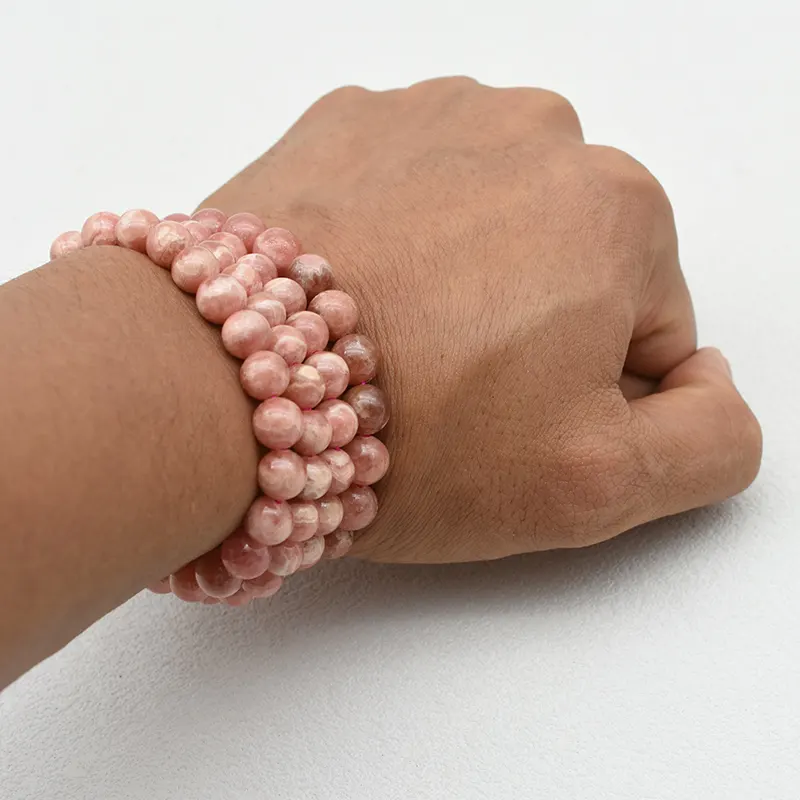 Rhodochrosite Bracelet Wholesale – pink beaded bracelets stacked on a wrist