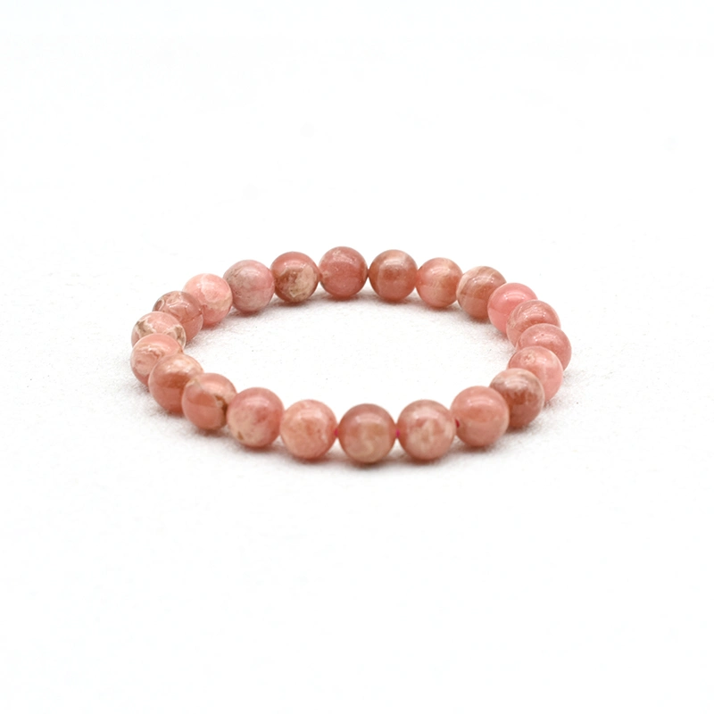 Rhodochrosite Bracelet Wholesale – single pink round bead bracelet on a white background