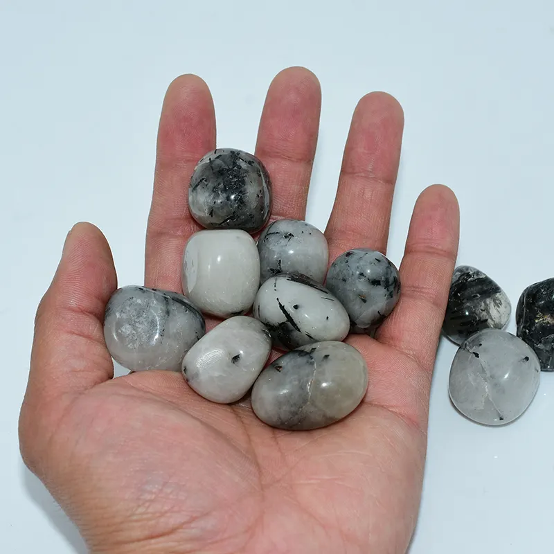 Tumbled Tourmalinated Quartz Wholesale – hand holding stones to show their size and appearance