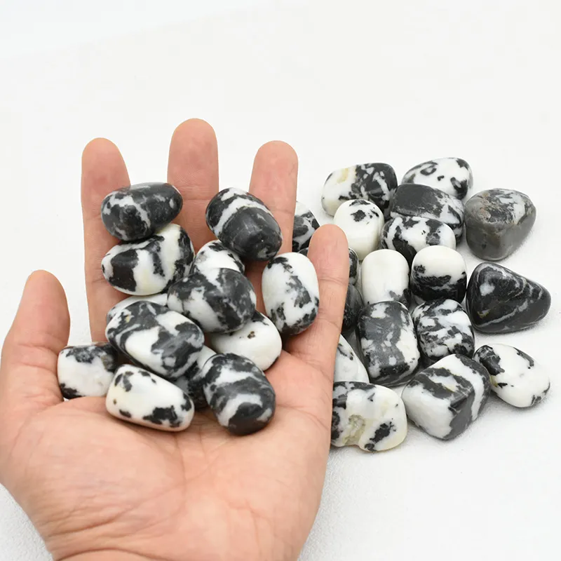 Zebra Jasper Tumbled Stone Wholesale – handful of tumbled stones with more pieces in the background
